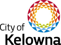 The City of Kelowna logo with black letters, and a symbol of a graphic sun with multiple colours like the rainbow in the top right corner.